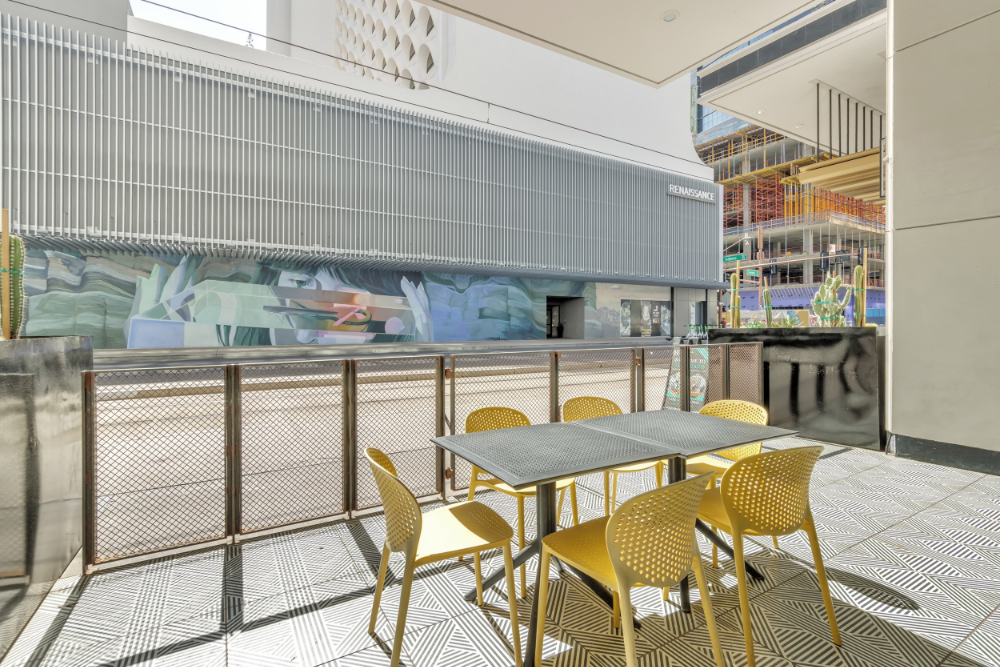 Bright Heard Building coworking lounge with tables, chairs and colorful wall art